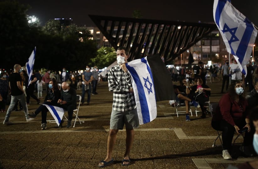 Israelis gather at Rabin Square in Tel Aviv for a remembrance ceremony marking 25 years since the assassination of late Israeli Prime Minister Yitzhak Rabin, held on November 7, 2020. (photo credit: MIRIAM ALSTER/FLASH90)