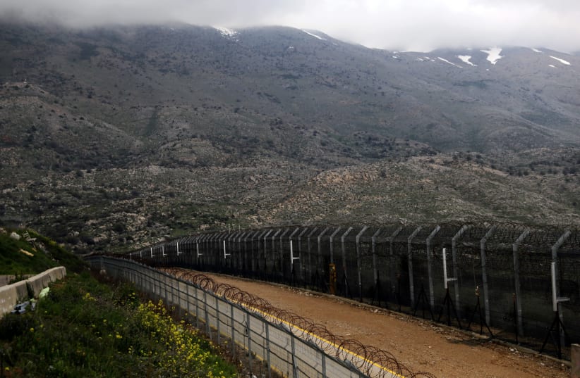 Fences are seen on the ceasefire line between Israel and Syria in the Golan Heights March 25, 2019. (photo credit: AMMAR AWAD/REUTERS)