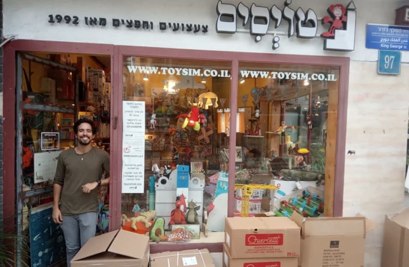 Toysim owner Tzuf Solomon at the front of his store. The interview was done while he was wearing a mask (photo credit: HAGAY HACOHEN)