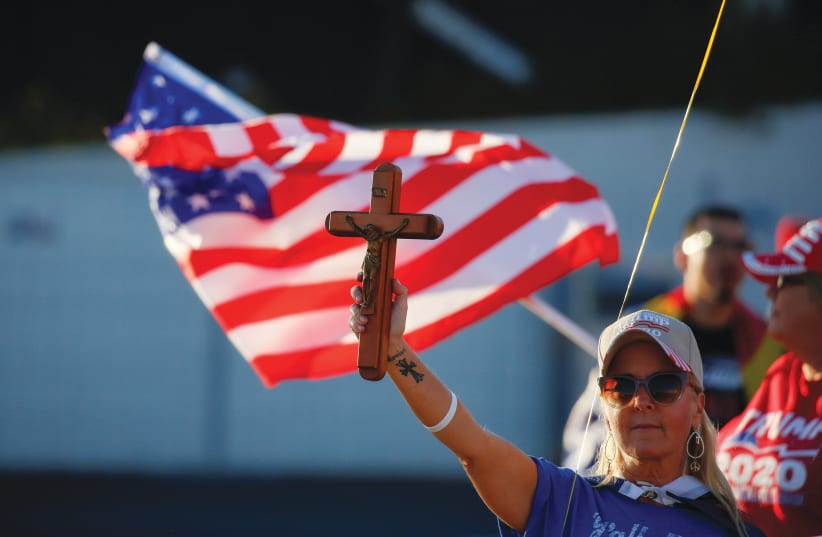 A SUPPORTER of US President Donald Trump holds a crucifix during a ‘Stop the Steal’ protest at the Maricopa County Tabulation and Election Center in Phoenix, Arizona, on Wedndesday. (photo credit: JIM URQUHART/REUTERS)