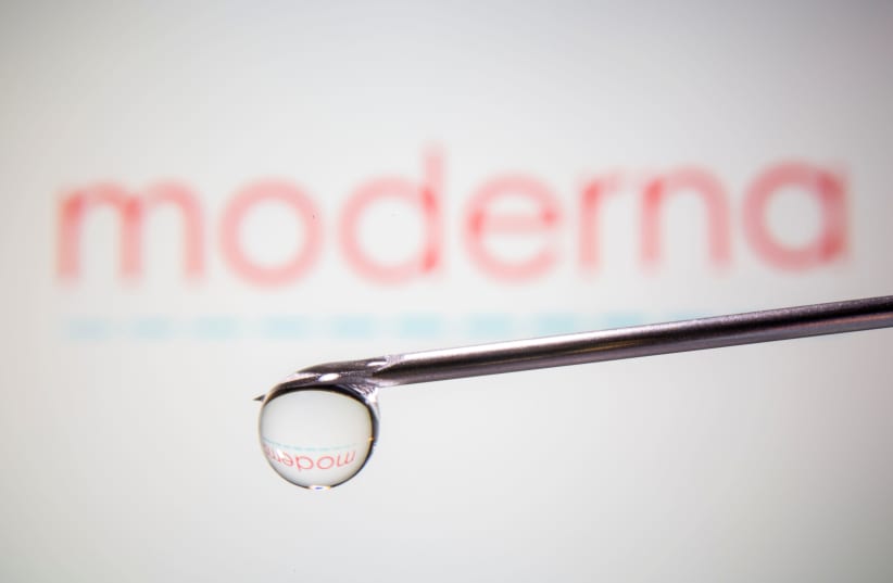 Moderna's logo is reflected in a drop on a syringe needle in this illustration taken November 9, 2020. (photo credit: REUTERS)