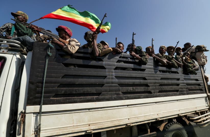 Members of Amhara region militias ride on their truck as they head to face the Tigray People's Liberation Front (TPLF), in Sanja, Amhara region near a border with Tigray, Ethiopia November 9, 2020.  (photo credit: REUTERS/TIKSA NEGERI)