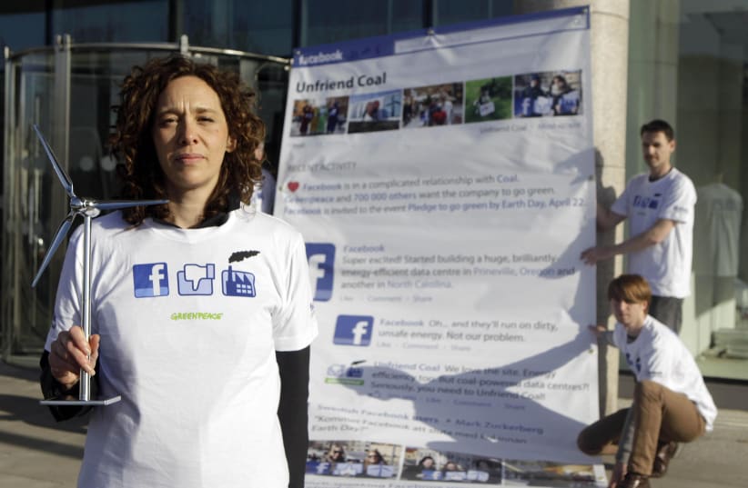 Climate activist Tzeporah Berman leads Irish Greenpeace volunteers in a protest outside Facebook's Dublin office calling on them to change the type of energy they use. (photo credit: NIALL CARSON/PA IMAGES VIA GETTY IMAGES)