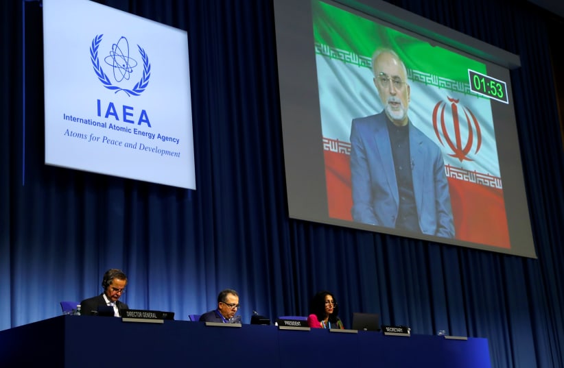 IAEA director-general Rafael Grossi listens as head of Iran's Atomic Energy Organization Ali-Akbar Salehi delivers his speech at the opening of the IAEA General Conference at their headquarters in Vienna, Austria September 21, 2020 (photo credit: REUTERS/LEONHARD FOEGER)