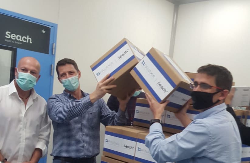 From right to left: Seach Medical Group CEO Yogev Sarid, Panaxia CEO Dadi Segal and Head of Israel's Medical Cannabis Unit Yuval Landschaf stand alongside the first commercial shipment of medical cannabis from Israel. (photo credit: Courtesy)