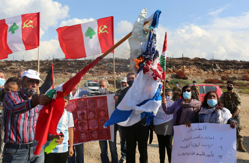 BURNING AMERICAN and Israeli flags in protest of talks on disputed maritime borders with Israel, in Naqoura near the Lebanese-Israeli border, November 11. (photo credit: AZIZ TAHER/REUTERS)