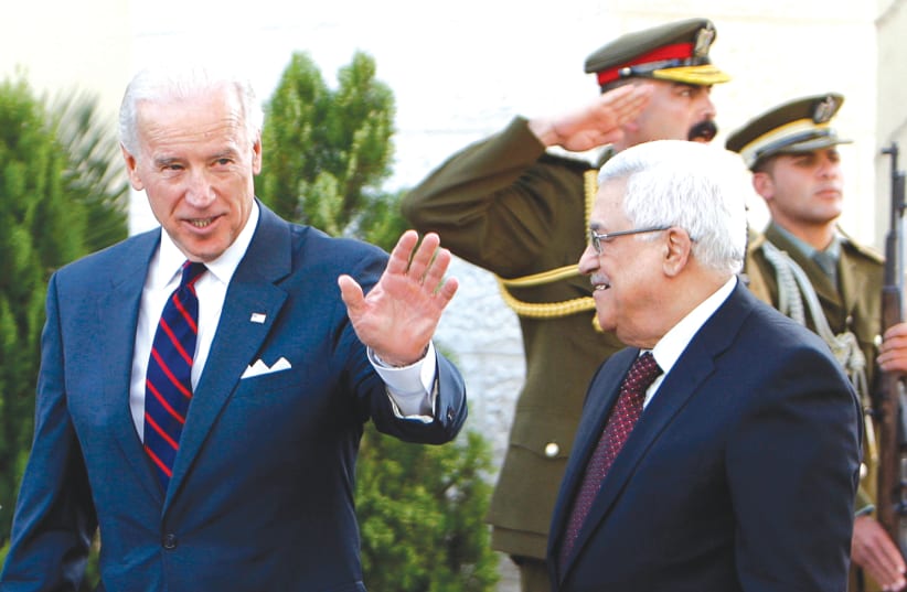 THEN-US vice president Joe Biden gestures as he walks with Palestinian Authority President Mahmoud Abbas after the two met in Ramallah in 2010. (photo credit: MOHAMAD TOROKMAN/REUTERS)