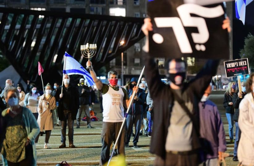 Socially distanced anti-Netanyahu protesters gather at Rabin Square in Tel Aviv, 21.11,2020. (photo credit: AVSHALOM SASSONI)