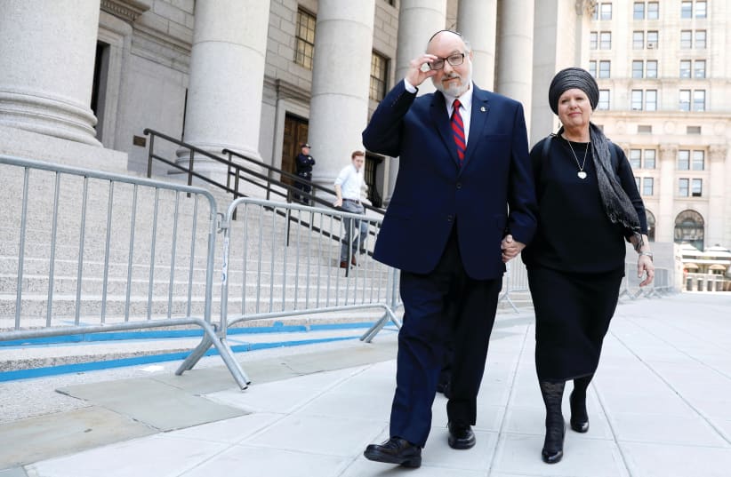 JONATHAN POLLARD and his wife, Esther, exit Manhattan Federal Courthouse in New York City, in 2017. (photo credit: BRENDAN MCDERMID/REUTERS)