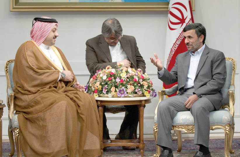 Iranian President Mahmoud Ahmadinejad (right) gestures as he attends an official meeting with Qatar’s Foreign Minister Adviser Khalid Mohammad al-Atiyeh in Tehran on October 13, 2011 (photo credit: MORTEZA NIKOUBAZI/ REUTERS)