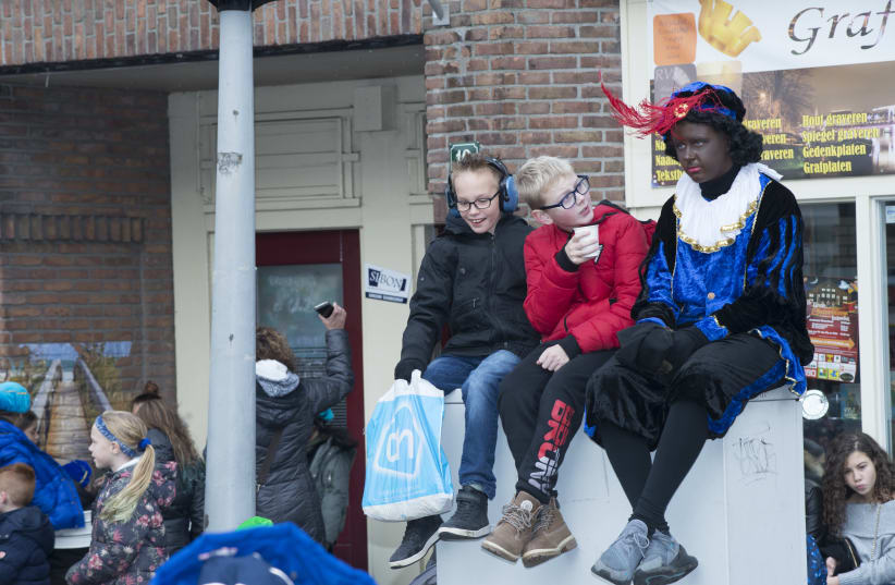 Children chat during a Black Pete event in Amsterdam, Nov. 16, 2019. (photo credit: CNAAN LIPHSHIZ/JTA)