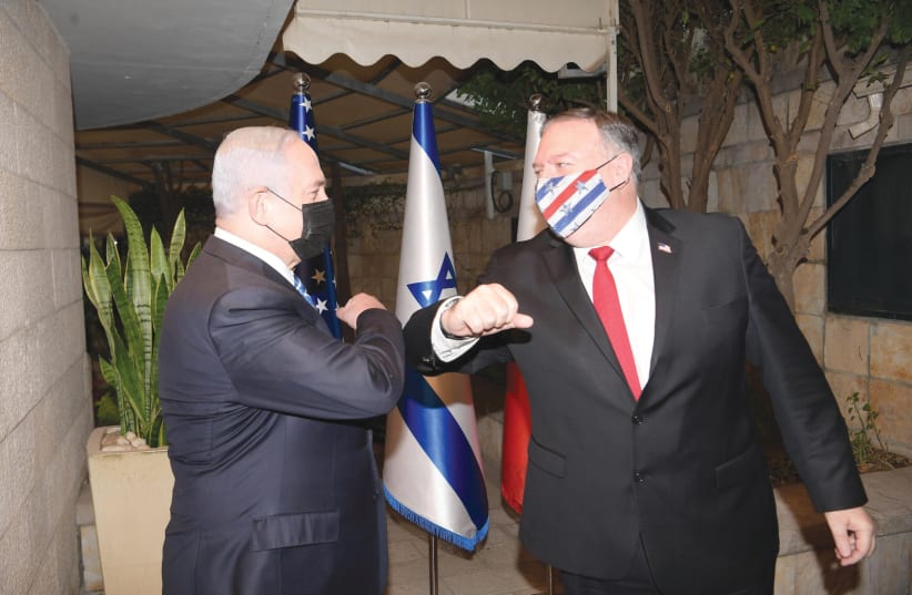 RIME MINISTER Benjamin Netanyahu greets US Secretary of State Mike Pompeo wearing a Stars and Stripes mask (photo credit: AMOS BEN GERSHOM, GPO)