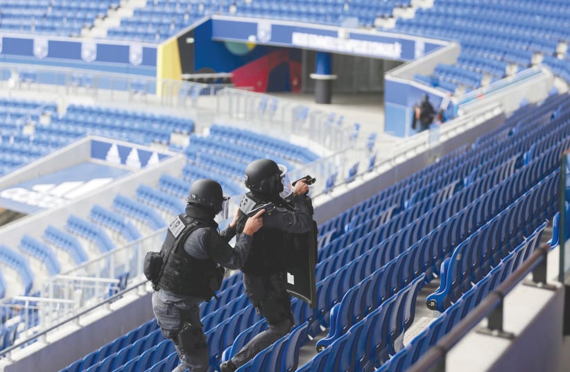 French special police take part in a drill inside Groupama Stadium near Lyon (photo credit: EMMANUEL FOUDROT/ REUTERS)
