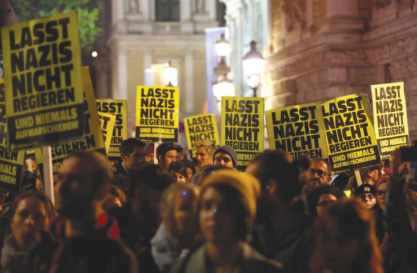 Posters saying, "Don't let Nazis rule" during a protest in Vienna, 2018 (photo credit: LEONHARD FOEGER / REUTERS)