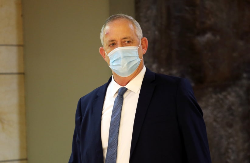 sraeli Defence Minister Benny Gantz wears a protective face mask as he arrives to attend a vote on the approval of the normalisation deal with the United Arab Emirates at the Knesset, Israel's parliament, in Jerusalem October 15, 2020. (photo credit: ALEX KOLOMOISKY / POOL)
