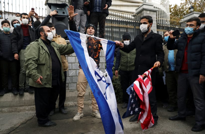  Protesters burn the US and Israeli flags during a demonstration against the the killing of Mohsen Fakhrizadeh, Iran's top nuclear scientist, in Tehran, Iran, November 28, 2020. (photo credit: MAJID ASGARIPOUR/WANA (WEST ASIA NEWS AGENCY) VIA REUTERS)