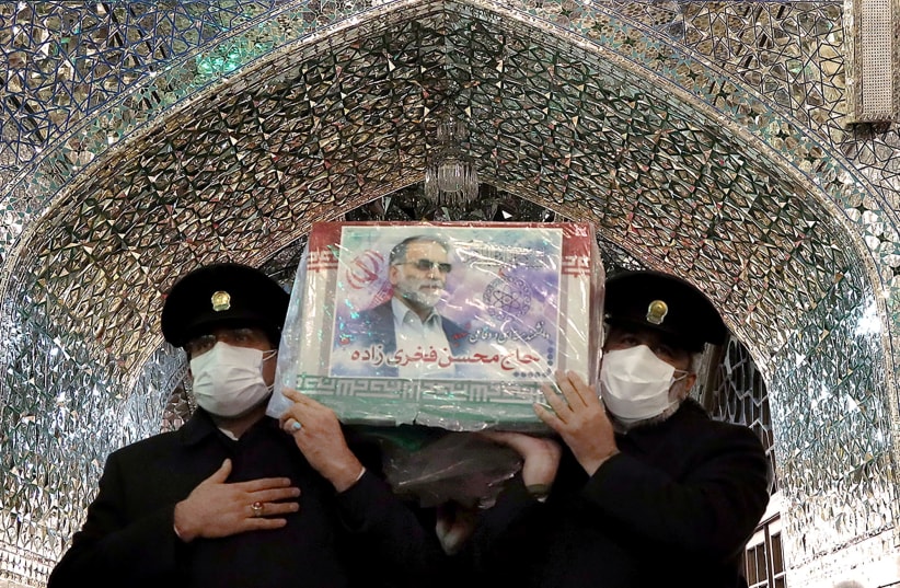 Servants of the holy shrine of Imam Reza carry the coffin of Iranian nuclear scientist Mohsen Fakhrizadeh, in Mashhad, Iran November 29, 2020.  (photo credit: MASSOUD NOZARI/WANA VIA REUTERS)