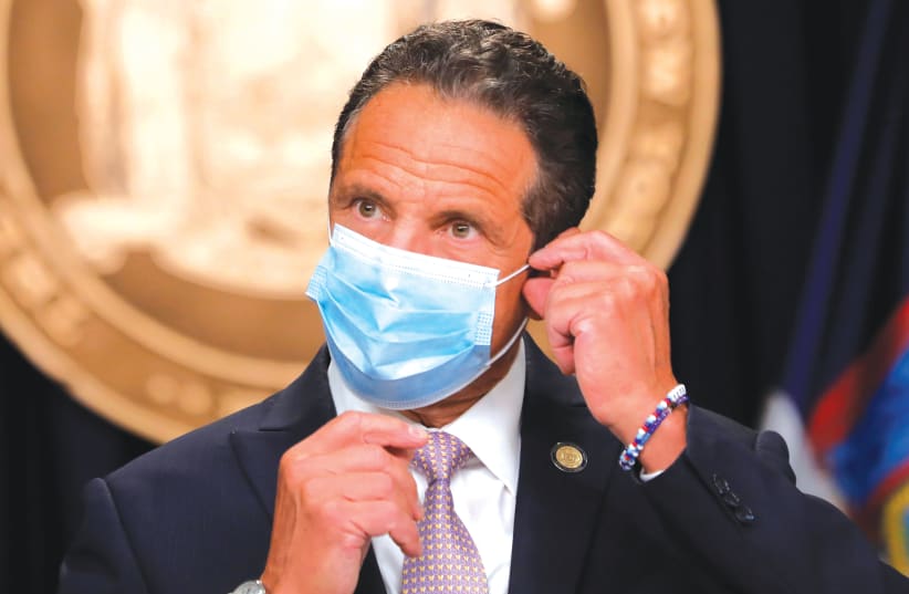 NEW YORK Gov. Andrew Cuomo wears a face mask as he arrives at a daily briefing in New York City in July. (photo credit: MIKE SEGAR / REUTERS)