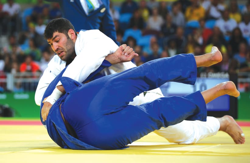 OR SASSON of Israel (in white) and Islam El Shehaby of Egypt compete at the 2016 Olympics in Rio de Janeiro, Brazil. (photo credit: TORU HANAI / REUTERS)