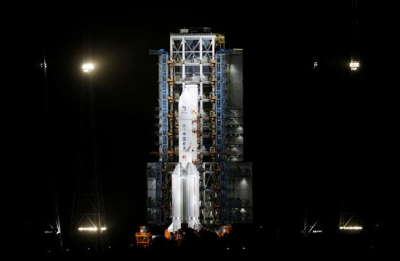 The Long March-5 Y5 rocket, carrying the Chang'e-5 lunar probe, is seen before taking off from Wenchang Space Launch Center, in Wenchang, Hainan province, China November 24, 2020. (photo credit: REUTERS/TINGSHU WANG)