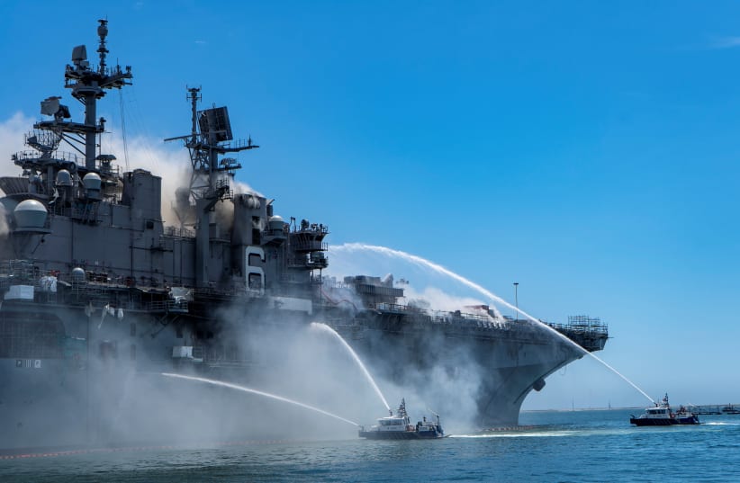 Port of San Diego Harbor Police Department boats combat a fire on board the US Navy amphibious assault ship USS Bonhomme Richard at Naval Base San Diego, California, US July 12, 2020. (photo credit: US NAVY/MASS COMMUNICATION SPECIALIST 3RD CLASS CHRISTINA ROSS/HANDOUT VIA REUTERS)