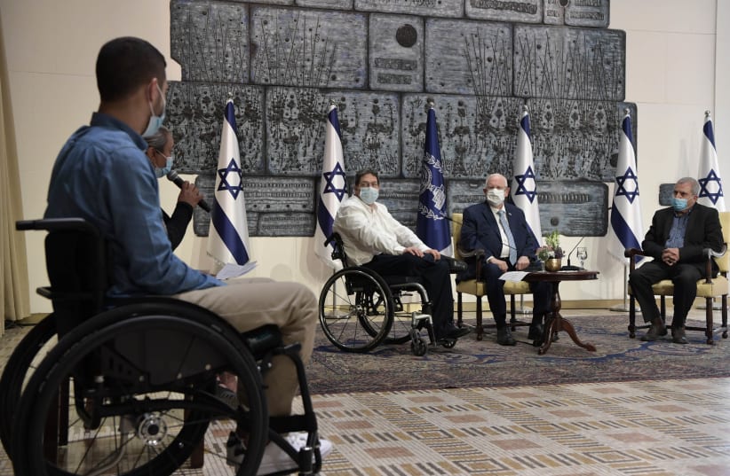President Reuven Rivlin is seen meeting with disabled IDF veterans on December 2, 2020. (photo credit: KOBI GIDEON/GPO)