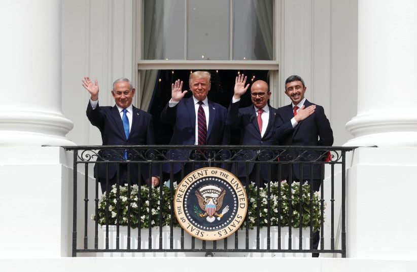(FROM LEFT) Prime Minister Benjamin Netanyahu, US President Donald Trump, Bahrain’s Foreign Minister Abdullatif al Zayani and UAE Foreign Minister Abdullah bin Zayed wave from a balcony overlooking the South Lawn of the White House in Washington, after a signing ceremony for the Abraham Accords on S (photo credit: TOM BRENNER/REUTERS)