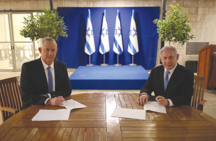 If he only knew then. Benny Gantz and Benjamin Netanyahu sign their coalition agreement on April 20 in Jerusalem. (photo credit: PRIME MINISTER'S OFFICE)