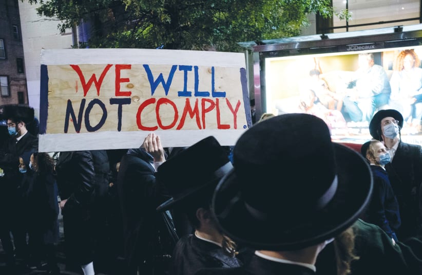 Ultra-Orthodox Jews gather in the Borough Park neighborhood of Brooklyn to protest against coronavirus restrictions, in October. (photo credit: YUKI IWAMURA/REUTERS)
