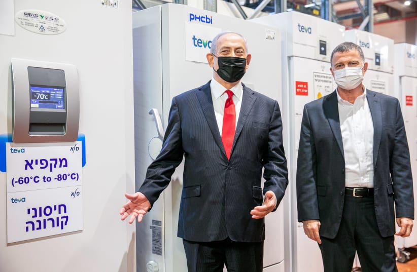 Israeli prime minister Benjamin Netanyahu and Minister of Health Yuli Edelstein visit at Teva Pharmaceuticals' logistics center in Shoham, where coronavirus vaccines would be stored and distributed, on November 26, 2020.  (photo credit: YOSSI ALONI/FLASH90)