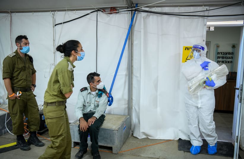 Israeli army Technicians carry out a diagnostic test for coronavirus in a IDF lab in central Israel on July 15, 2020. Photo by Yossi Zeliger/Flash90 (photo credit: YOSSI ZELIGER/FLASH90)