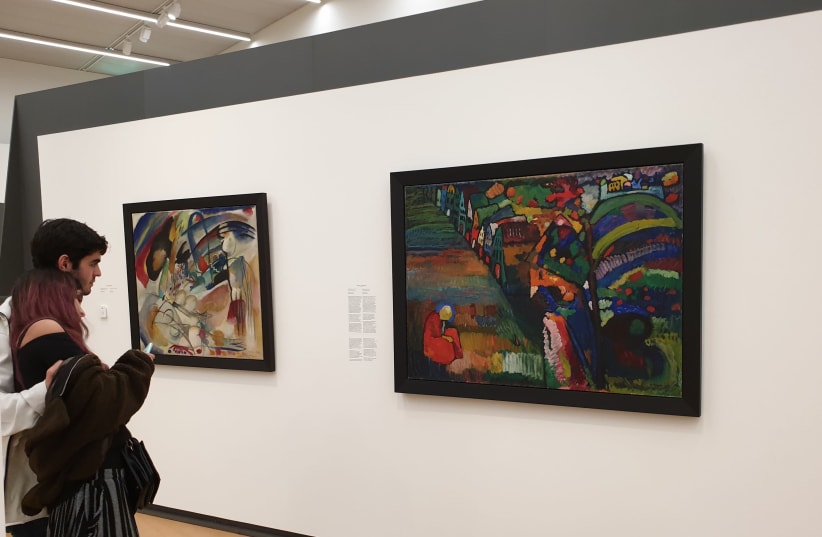Tourists stand near a disputed Wassily Kandinsky painting at the Stedelijk Museum in Amsterdam, July 10, 2019. (photo credit: CNAAN LIPHSHIZ/JTA)