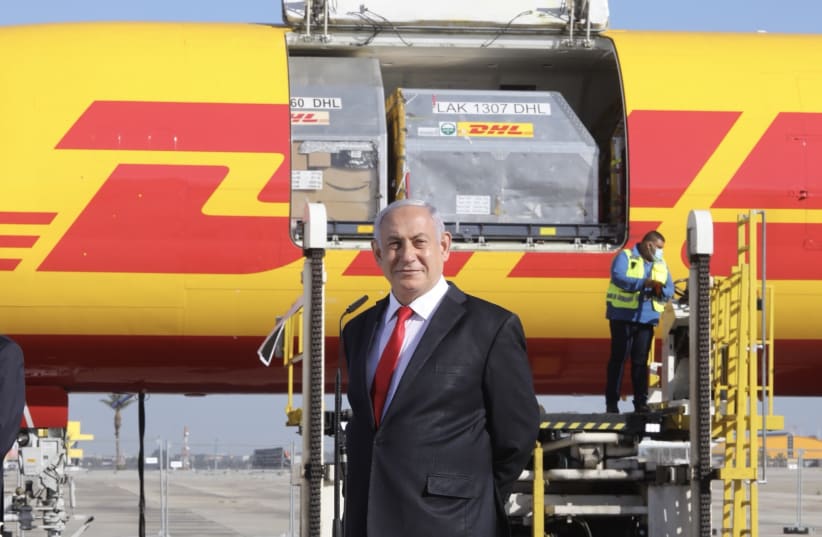 Prime Minister Benjamin Netanyahu welcomes the first shipment of Pfizer's coronavirus vaccine to Ben-Gurion Airport, Israel, December 9, 2020 (photo credit: MARC ISRAEL SELLEM/THE JERUSALEM POST)