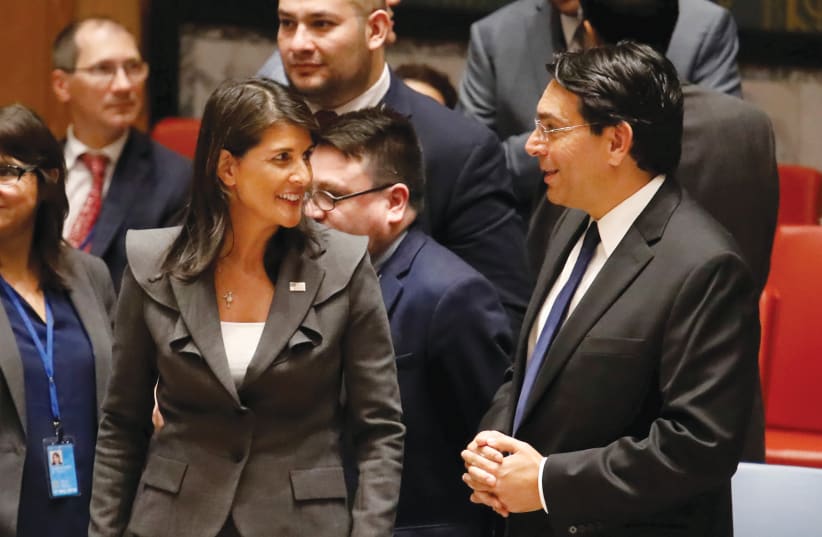 NIKKI HALEY and Danny Danon talk before a Security Council vote at UN headquarters in 2018. (photo credit: SHANNON STAPLETON / REUTERS)