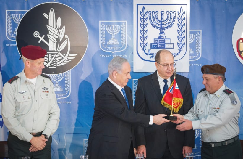 IS THE GANG getting back together again? Prime Minister Benjamin Netanyahu and then-defense minister Moshe Ya’alon present Gadi Eizenkot with the IDF pennant when he replaced Benny Gantz in 2015 as chief of staff. (photo credit: MIRIAM ALSTER/FLASH90)