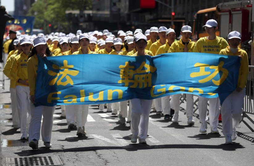 Members of Falun Gong or Falun Dafa, a Chinese religious spiritual practice, march to the Consulate General of the People's Republic of China in New York City, US, May 16, 2019.  (photo credit: REUTERS/SHANNON STAPLETON)