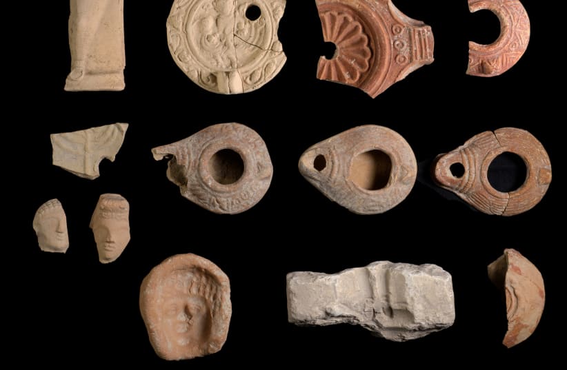 Ceramic oil lamps and stone lamp molds for their production were found along with terracotta figurines, December, 2020 (photo credit: DAFNA GAZIT/ISRAEL ANTIQUITIES AUTHORITY)