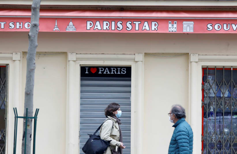 A closed tourist souvenir shop is seen before the national lockdown introduced as part of the new COVID-19 measures to fight a second wave of the coronavirus disease, in Paris, France, October 29, 2020. (photo credit: REUTERS/CHARLES PLATIAU/FILE PHOTO)