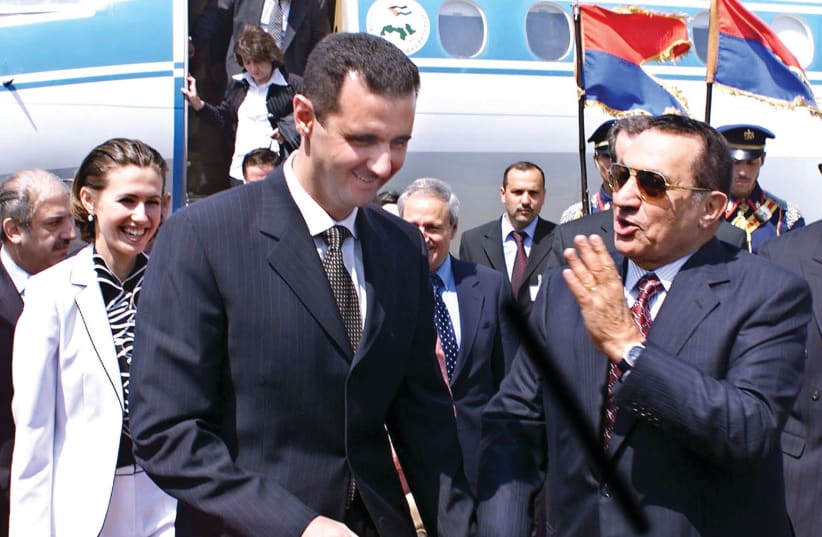 Egyptian President Hosni Mubarack (right) welcomes Syrian President Bashar Assad in Cairo 2002 (photo credit: SANA/REUTERS)