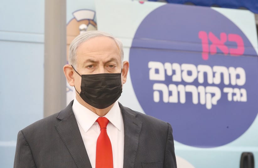 PRIME MINISTER Benjamin Netanyahu at a Maccabi vaccine center in Tel Aviv on Sunday. (photo credit: MARC ISRAEL SELLEM/THE JERUSALEM POST)