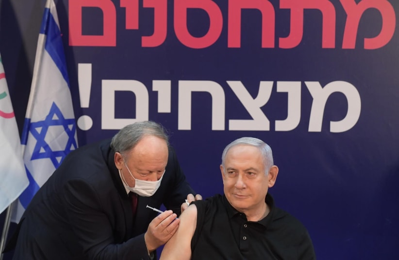 Prime Minister Benjamin Netanyahu gets vaccinated for the novel coronavirus. (photo credit: AMOS BEN-GERSHOM/GPO)