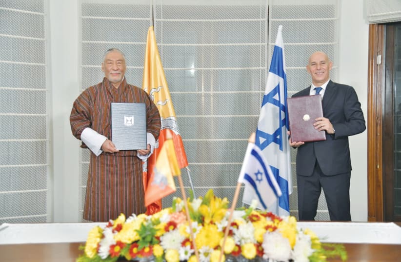 THE ISRAELI and Bhutanese ambassadors to India attend a signing ceremony establishing diplomatic relations between Israel and Bhutan, in the Israeli Embassy in New Delhi, India, on December 12.  (photo credit: COURTESY ISRAELI EMBASSY IN NEW DELHI/REUTERS)