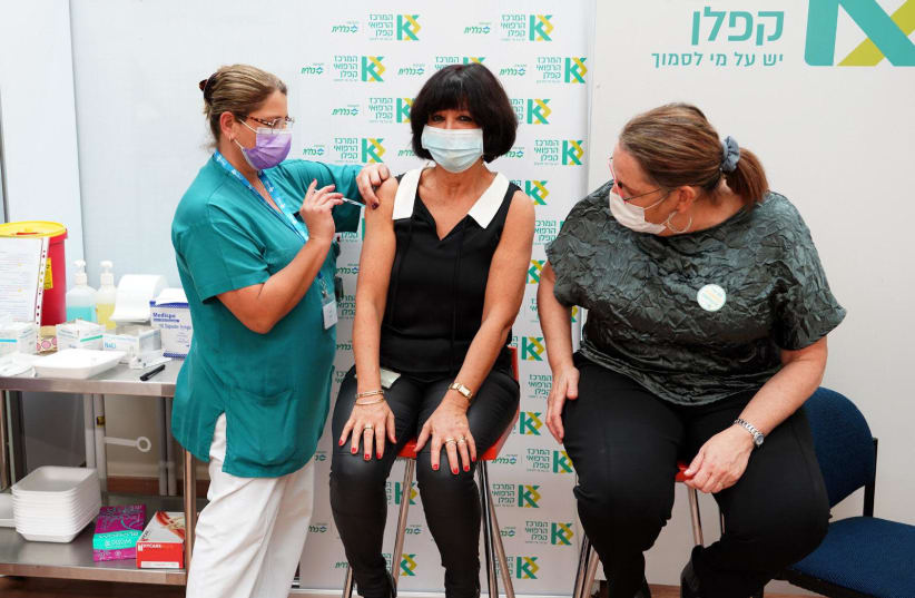 The coronavirus vaccine is seen being administered at Kaplan Medical Center in Rehovot on December 20, 2020. (photo credit: GILAD SHA'ABANI/KAPLAN MEDICAL CENTER)