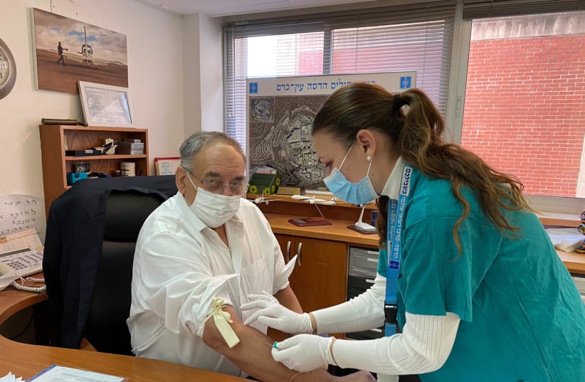 Photo of Prof. Zeev Rotstein, head of Hadassah-University Medical Center, being screened for eligibility to be vaccinated on Monday as part of the Phase II trial of the Israeli vaccine candidate Brilife. December 20, 2020 (photo credit: HADASSAH)