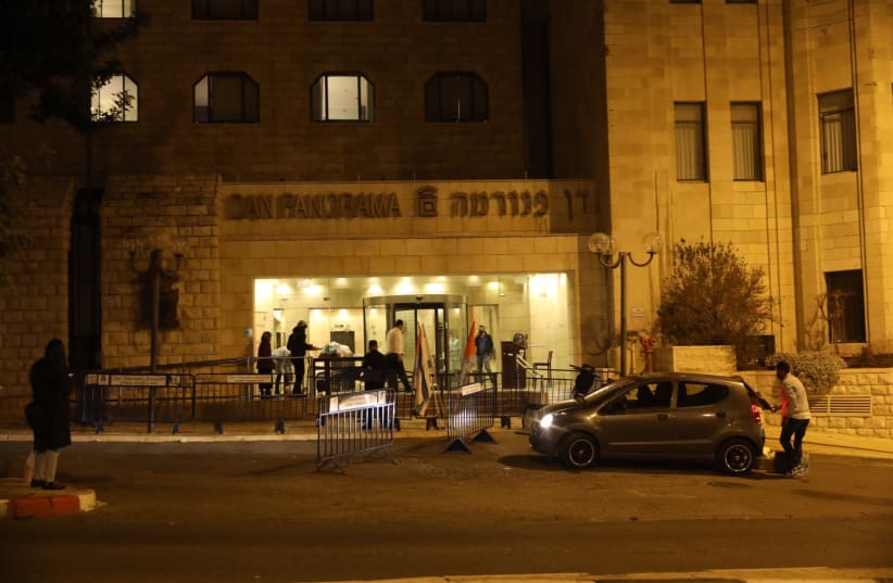Individuals get set up at a corona-designated hotel in Jerusalem, December 21, 2020.  (photo credit: MARC ISRAEL SELLEM)