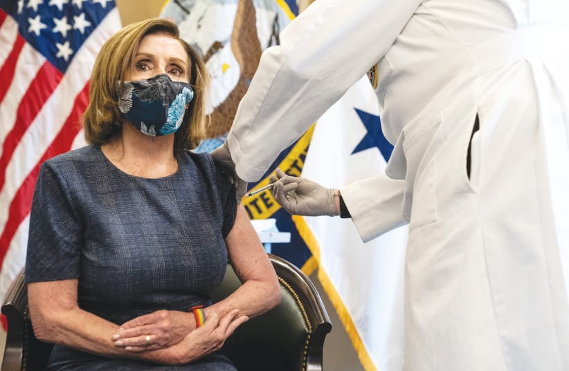 US SPEAKER of the House Nancy Pelosi receives the Pfizer-BioNTech COVID-19 vaccine at the Capitol in Washington, earlier this month. (photo credit: ANNA MONEYMAKER/REUTERS)