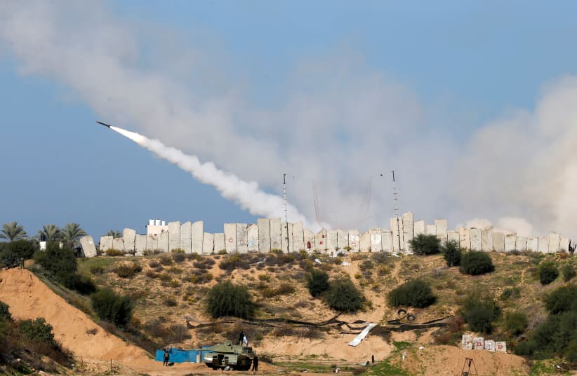A rocket is launched by Palestinian militant groups into the Mediterranean Sea off the Gaza Strip at the start of their first-ever joint exercise, in Gaza City December 29, 2020 (photo credit: REUTERS/MOHAMMED SALEM)