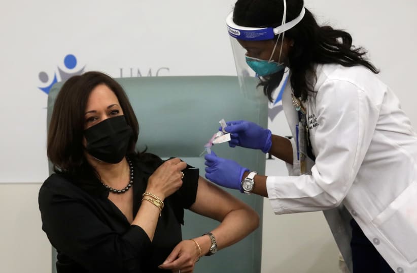 US Vice President-elect Kamala Harris receives a dose of the Moderna COVID-19 vaccine in Washington (photo credit: REUTERS)