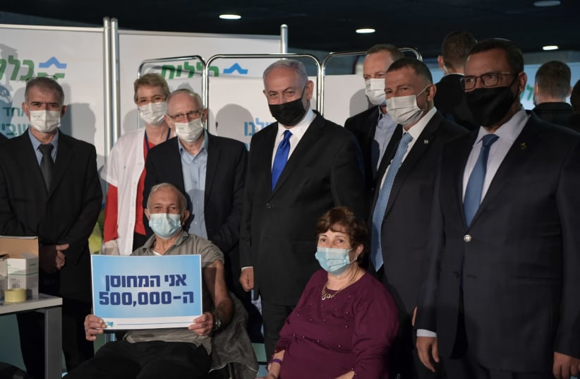 Prime Minister Benjamin Netanyahu and Health Minister Yuli Edelstein are seen with Herzl Levy, the 500,000th Israeli to be given the COVID-19 vaccine. (photo credit: KOBI GIDEON/FLASH90)