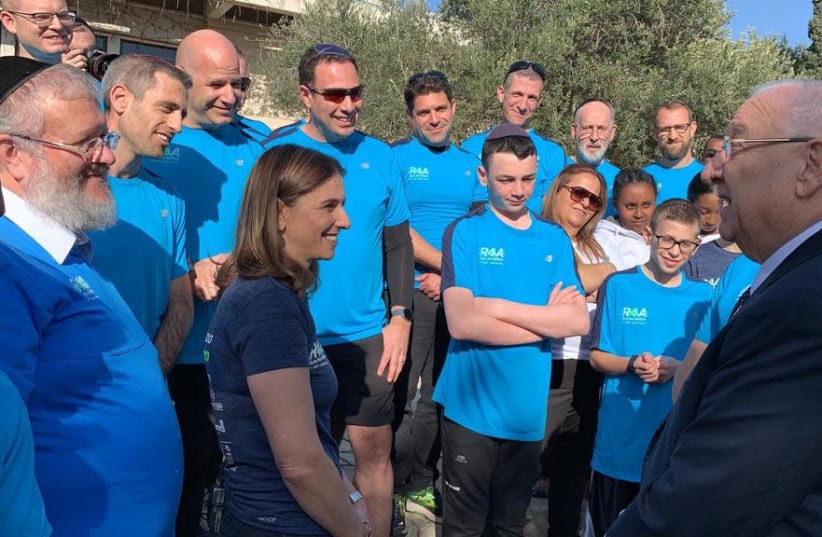 Afikim CEO Moshe Lefkowitz and co-founder of Run4Afikim Gila Rockman with the participants of the race at a meeting with President Reuven Rivlin, 2019.  (photo credit: COURTESY AFIKIM)